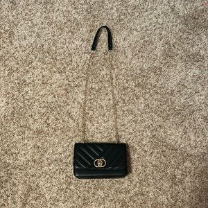 Black leather purse with gold chain.